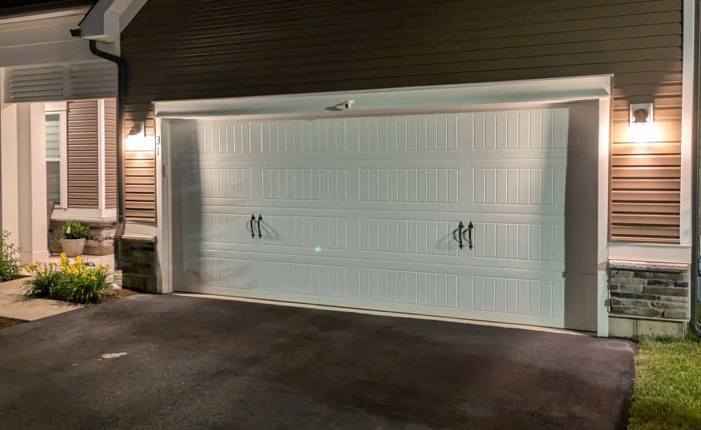 Ring and SimpliSafe entry sensor mounted on garage door