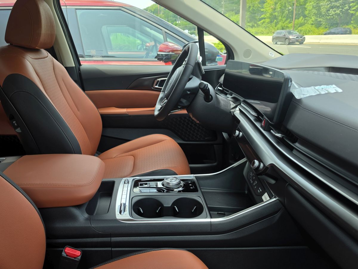 Kia Carnival phone mounts attach to the dashboard and center touchscreen interior