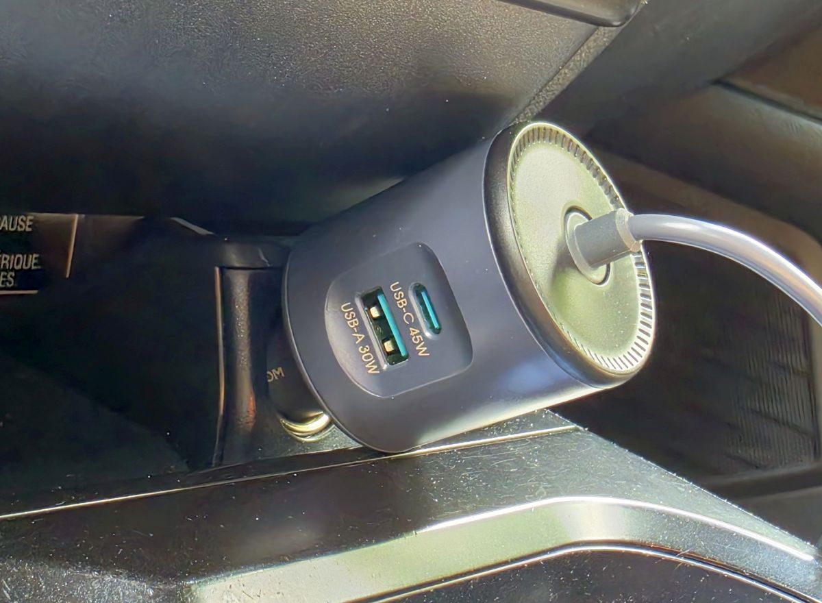 Starlink Power Adapter Starlink Mini car adapter plugged into a vehicle cigarette lighter socket with digital voltage display