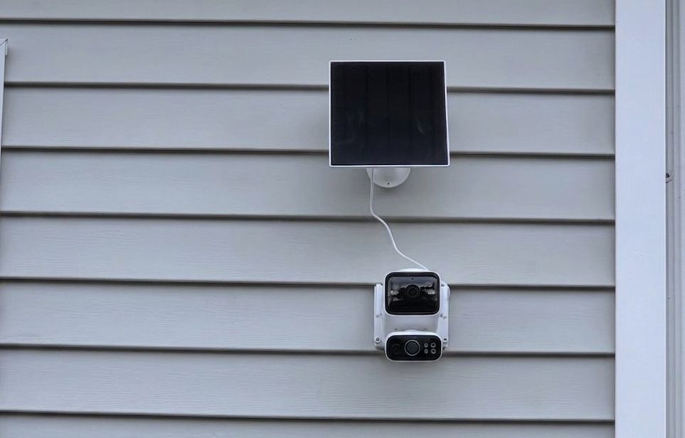 Tapo C675D Tapo C675D solar-powered outdoor security camera with A202 solar panel mounted on a home exterior
