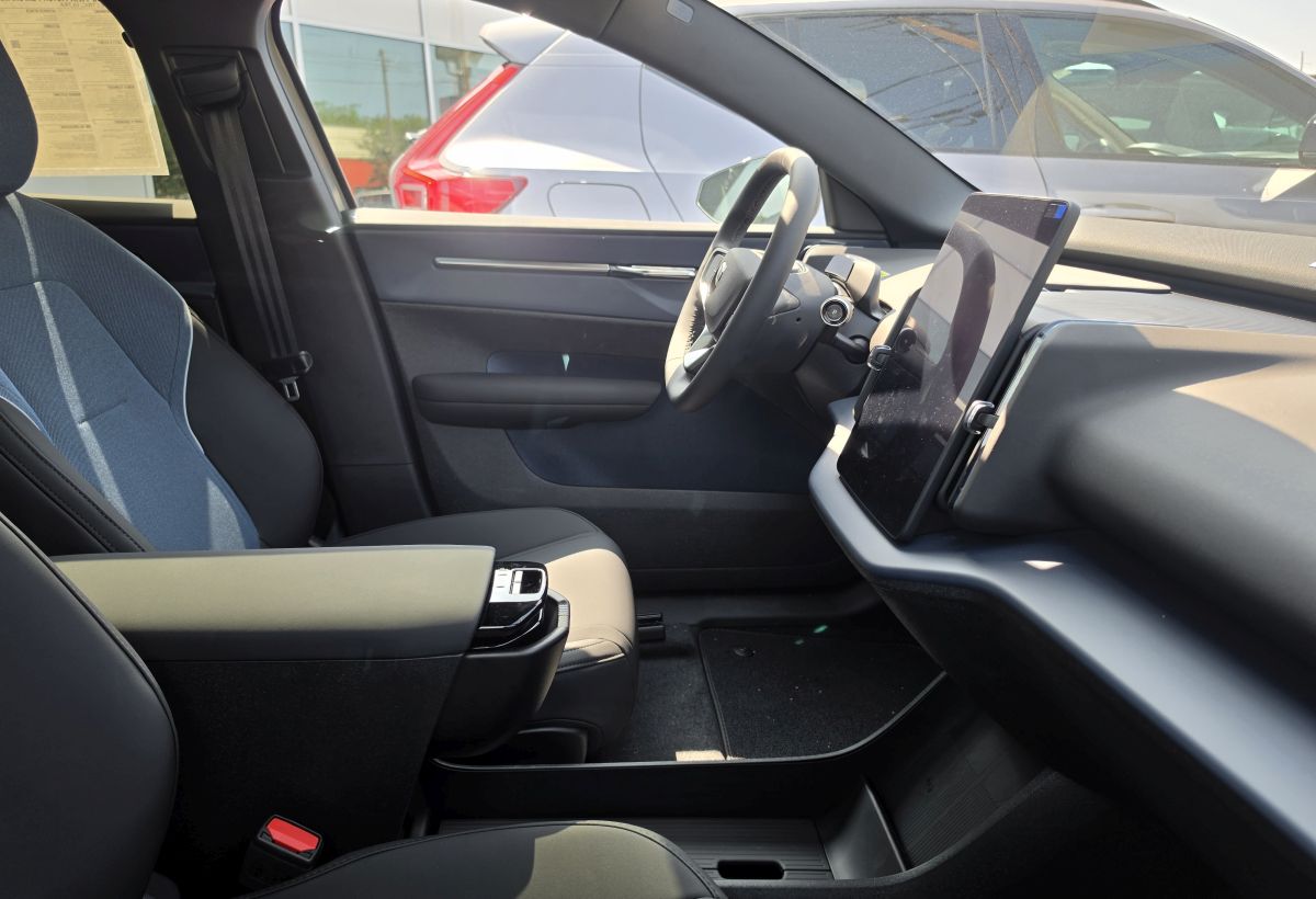 Volvo EX30 phone mounts for the dashboard showing the center touchscreen and console area for phone mount placement
