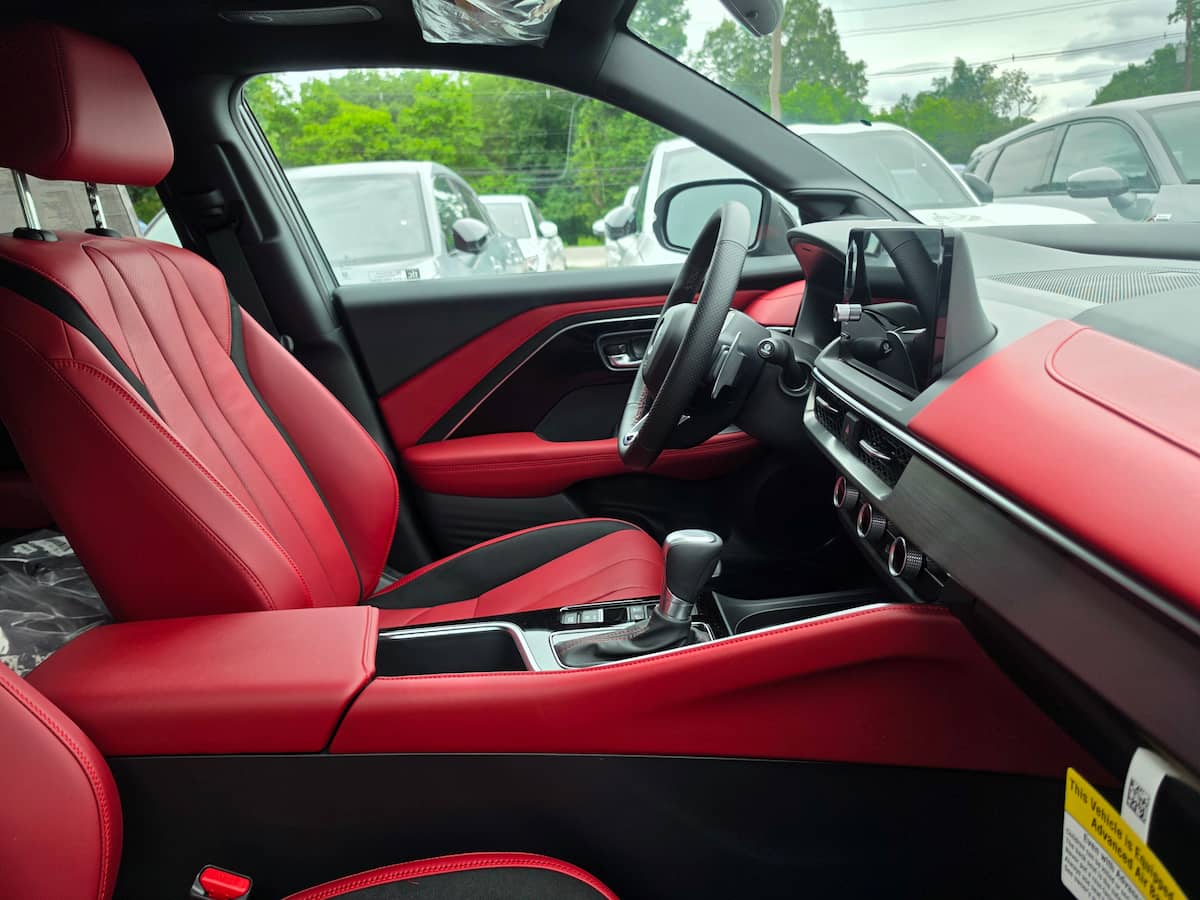 Acura ADX dashboard and center console showing infotainment screen and cup holder area