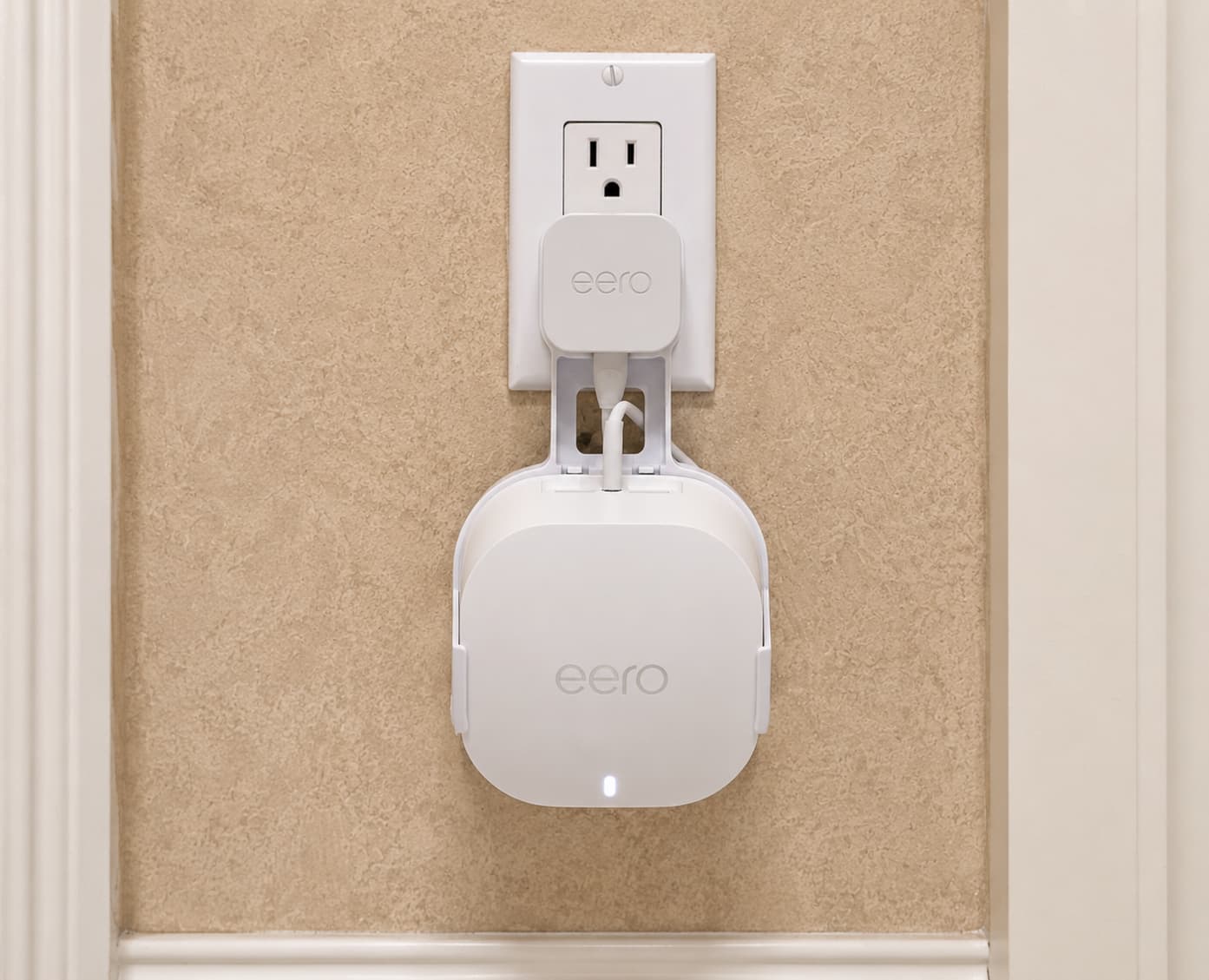 Eero Wall Mount eero mesh router mounted to a wall outlet using an outlet mount bracket