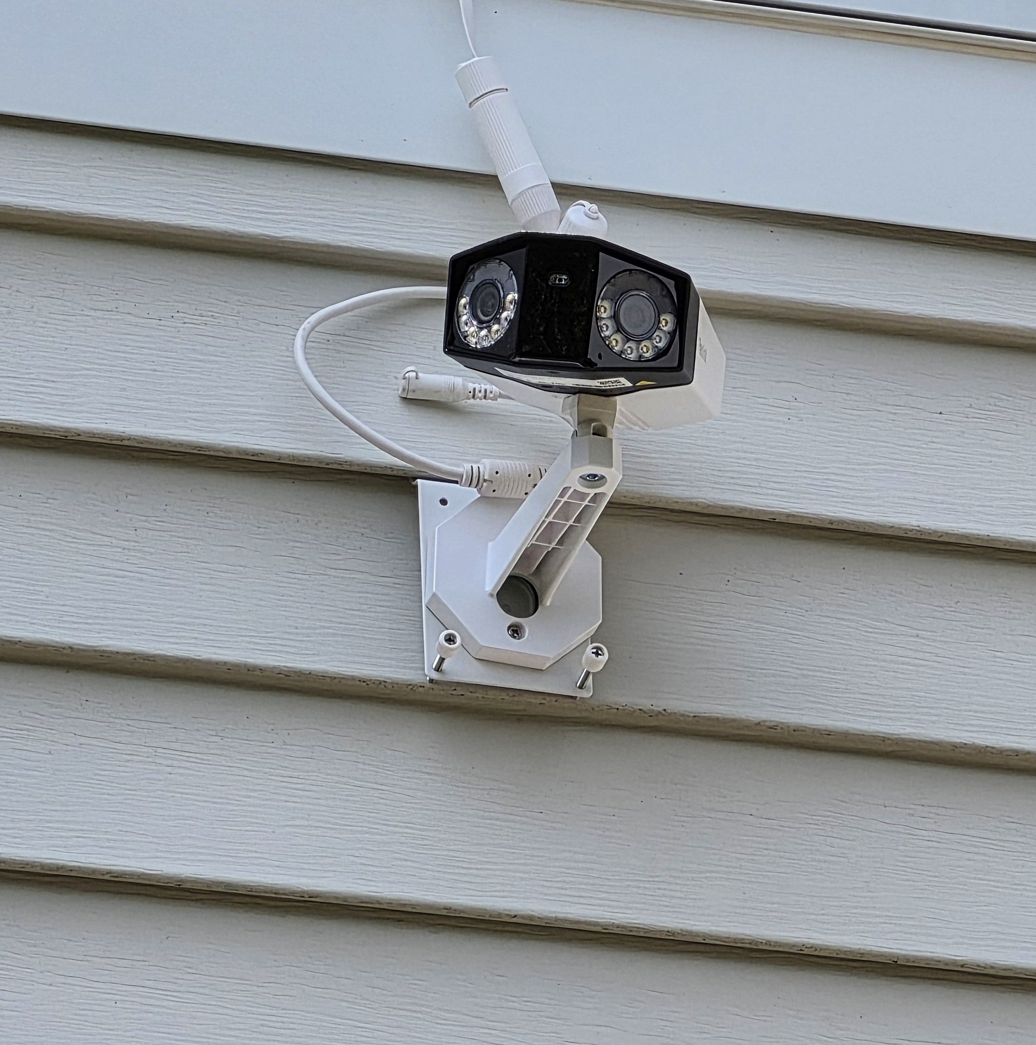 Reolink Duo 3 Square Reolink Duo 3 PoE installed on a siding mount bracket